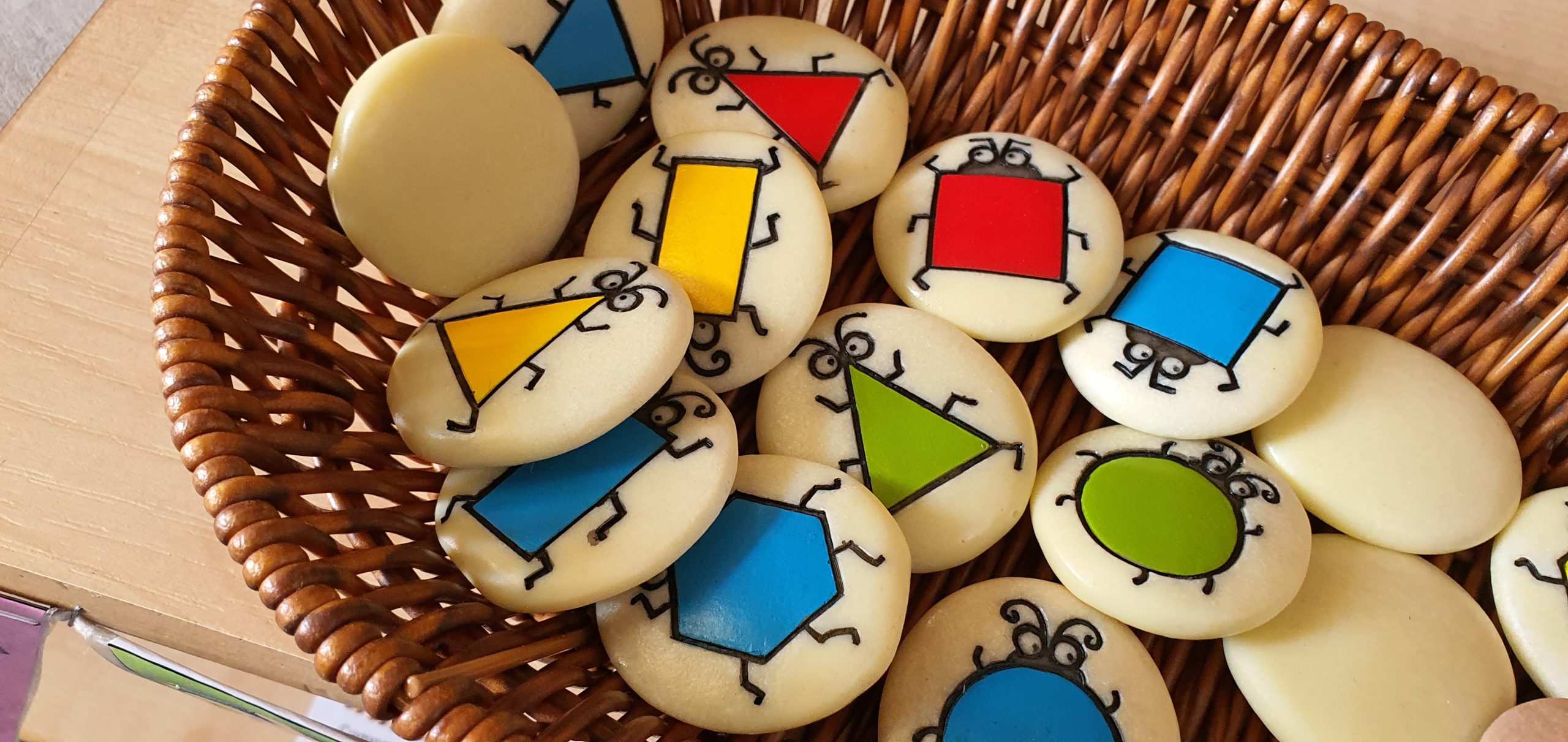 A variety of coins with colourful symbols on them.